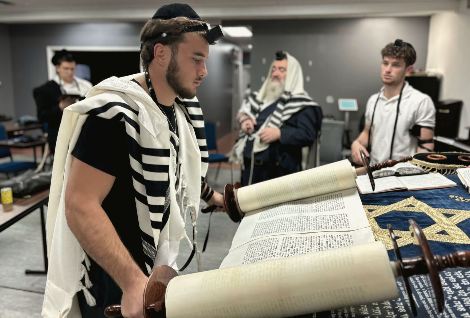 A talmid leining from the Sefer Torah